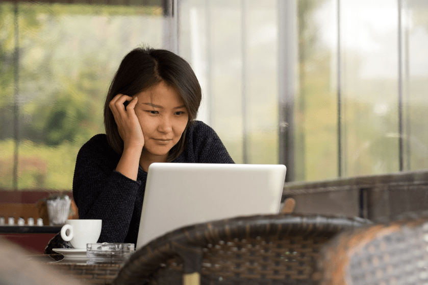 A woman works at a laptop.