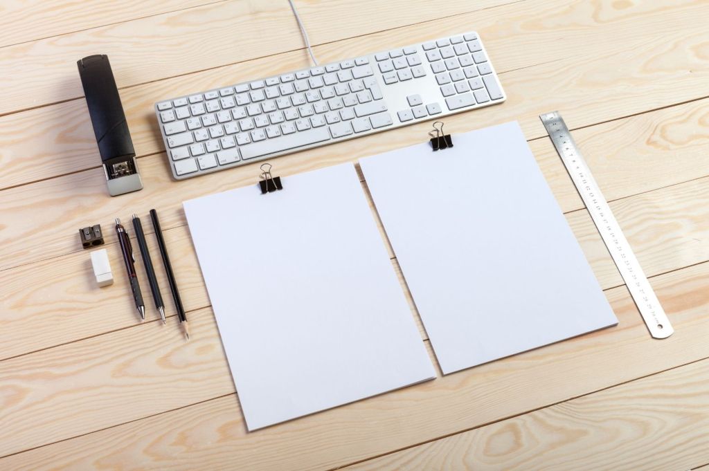 Stacks of paper sit on desk, ready to distribute.