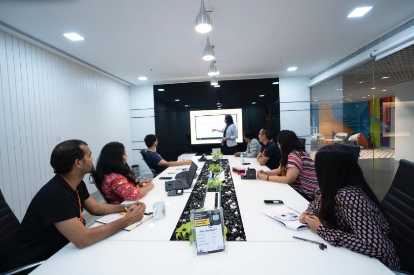 A group interview takes place in a conference room.