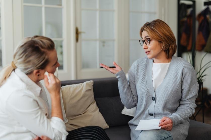 women sitting on the couch talking