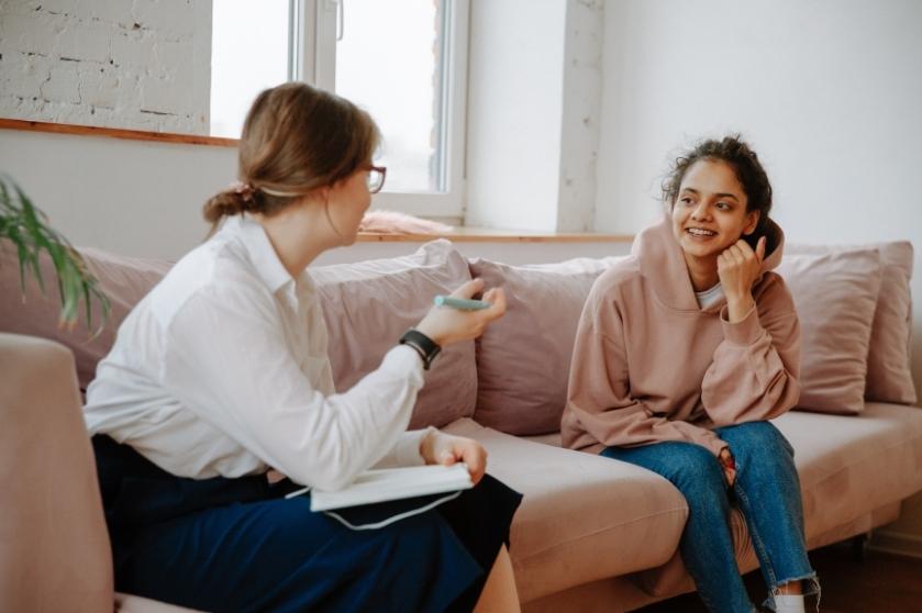 woman and teen sitting on couch