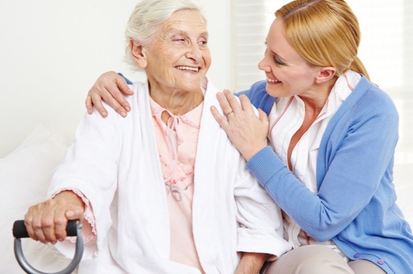 woman with arms around an elderly woman